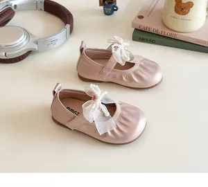 Close-up of pink Mary Jane shoes for girls featuring a mesh bow and pearl accents