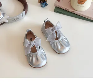 Detailed close-up of girls silver Mary Jane shoes with mesh bow and elastic trim
