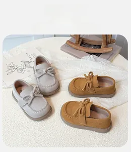 Detailed close-up of kids bow-knot loafers with non-slip soles and soft suede finish
