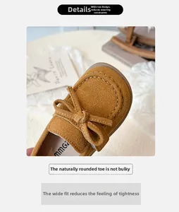 Detail of round toe caramel suede kids shoes with handmade stitching and bow