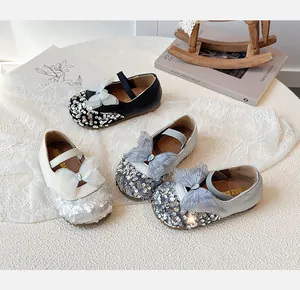 Detailed close-up of girls sequined Mary Jane flats with layered lace bow accents