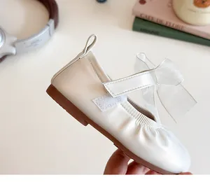 Detailed close-up of girls' Mary Jane shoes featuring a sheer organza bow and strap