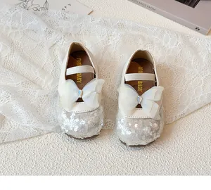 Detail of girls' Mary Jane shoes with sequins, organza bow and rhinestone on soft sole