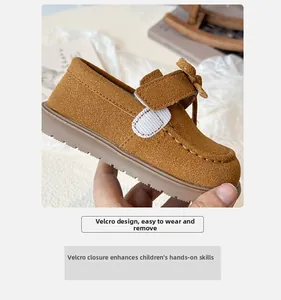 Detail of kids brown suede velcro loafers with easy-to-wear closure design