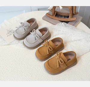 Classic kids suede loafers with bow detail and stitched toe in gray and brown colors