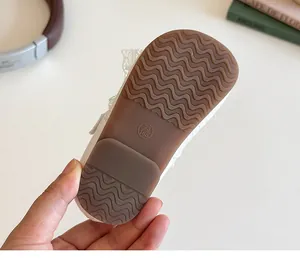 Detailed macro view of the non-slip rubber sole with size marking on girls' lace shoes