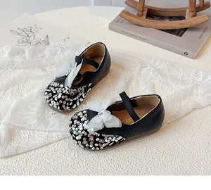Detail of sequin toe and mesh bow with crystal on girl's black Mary Jane shoes