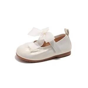 Elegant girls cream Mary Jane shoes featuring a sheer organza bow and velcro strap