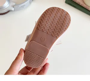 Close-up of flexible rubber sole with anti-slip wavy texture on girls princess shoes