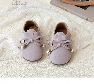 Detail view of lilac suede girls shoes with decorative bow and wooden beads accents