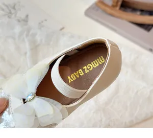 Detail view of the soft inner lining and sequined lace bow on the girls' beige princess shoe