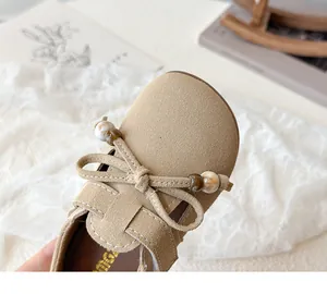 Detail of girls' khaki suede princess shoes with bowknot and decorative beads