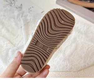 Detailed view of non-slip rubber sole on sequin princess shoes with wavy anti-skid pattern