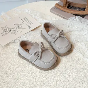 Grey suede girls' bow loafers with minimalist design shown from a top-down view