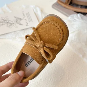 Classic brown suede kids loafers with a bow tie detail and comfortable round toe design