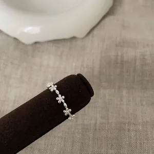 Detailed macro view of S925 sterling silver floral ring on a velvet display stand