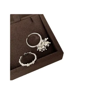 Silver firework flower open rings set displayed in a premium brown velvet jewelry box