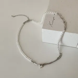 Dettaglio della collana di perle e metallo argento irregolare con chiusura a moschettone