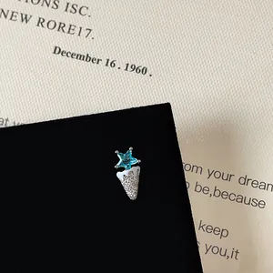 Macro view of blue star gem and white enamel screw back stud with pavé zircon stones