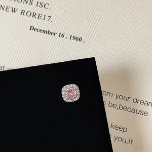 Macro shot of pink zircon stud earrings with square halo setting and screw back