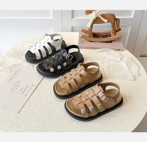 Macro shot of Roman-style kids' sandals with vintage metal buckles and non-slip thick soles