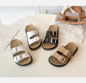 Macro detail of children hollow sandals with adjustable metal buckles and soft cork footbed
