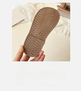 Close-up of anti-slip wavy textured rubber sole on kids sandals with size 28 marking