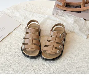 Close-up of brown platform sandals with metal flower studs and non-slip sole details