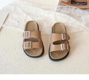 Close-up of brown double-buckle slides with ergonomic footbed and non-slip sole