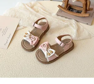 Detail of pink bow sandals for girls with non-slip rubber soles and adjustable straps