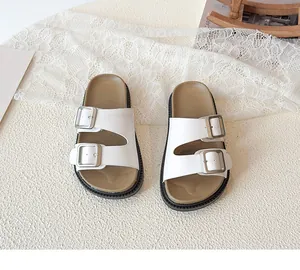 Detail view of girls' white PU leather sandals featuring dual silver adjustable metal buckles