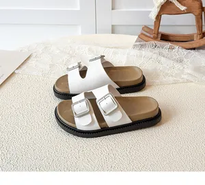 Detailed side view of platform kids sandals with white straps and silver metal buckles