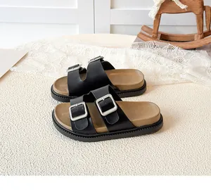 Detail of kids casual slide sandals with double silver buckles and ergonomic brown footbed