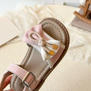 Pink and white girls bow sandals with adjustable metal buckles and stylish stitching