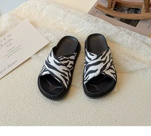 Macro detail of zebra print cross strap children's slippers with thick soft soles