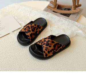 Close-up of leopard print cross-strap slides with thick black anti-slip soles for summer