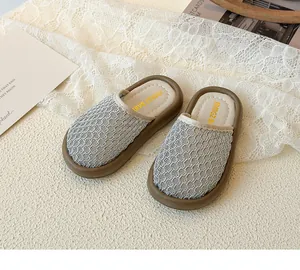 Detail of silver mesh hollow-out upper and thick rubber sole on girls' sandals