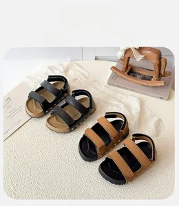 Top view of two pairs of kids open-toe sandals in black and brown with velcro straps