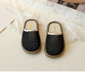 Detailed macro view of black honeycomb mesh and gold logo on toddler princess mule