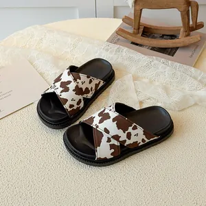 Children's thick-soled slide sandals with brown cow print straps and non-slip rubber sole