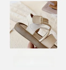 Detail of soft beige straps and adjustable velcro closure on kids fashion sandals