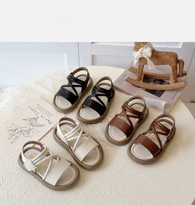 Detailed view showing children's cross-strap sandals in black, cream, and brown options