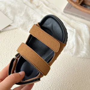 Breathable kids brown faux suede sandals with flexible black soles and velcro straps