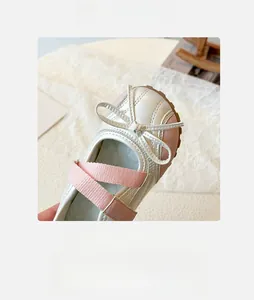 Detailed top view of girl's Mary Jane shoes with bow decoration and pink elastic straps