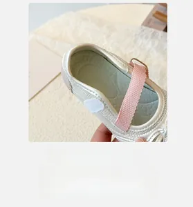 Detail of silver girls Mary Jane shoes featuring arch support and breathable lining