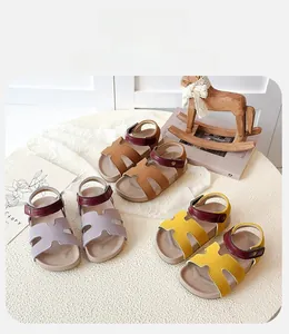 Detailed overhead view of three open-toe children's sandals with H-shaped straps