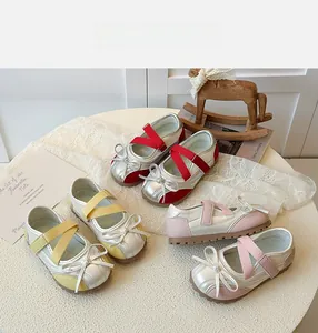 Detail of girls' metallic Mary Jane shoes with mesh panels and decorative bows in three colors