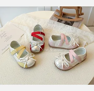 Top view of metallic silver girls Mary Jane shoes with colorful bows and elastic straps