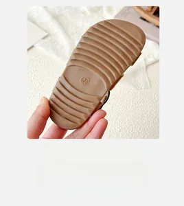 Close-up of brown rubber sole with non-slip wave texture for kids beach sandals