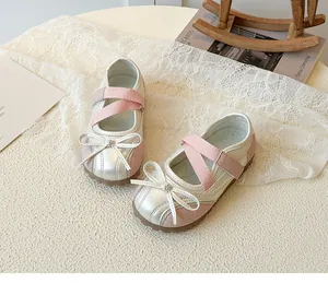Detail view of silver and pink girls Mary Jane shoes with bow and elastic straps